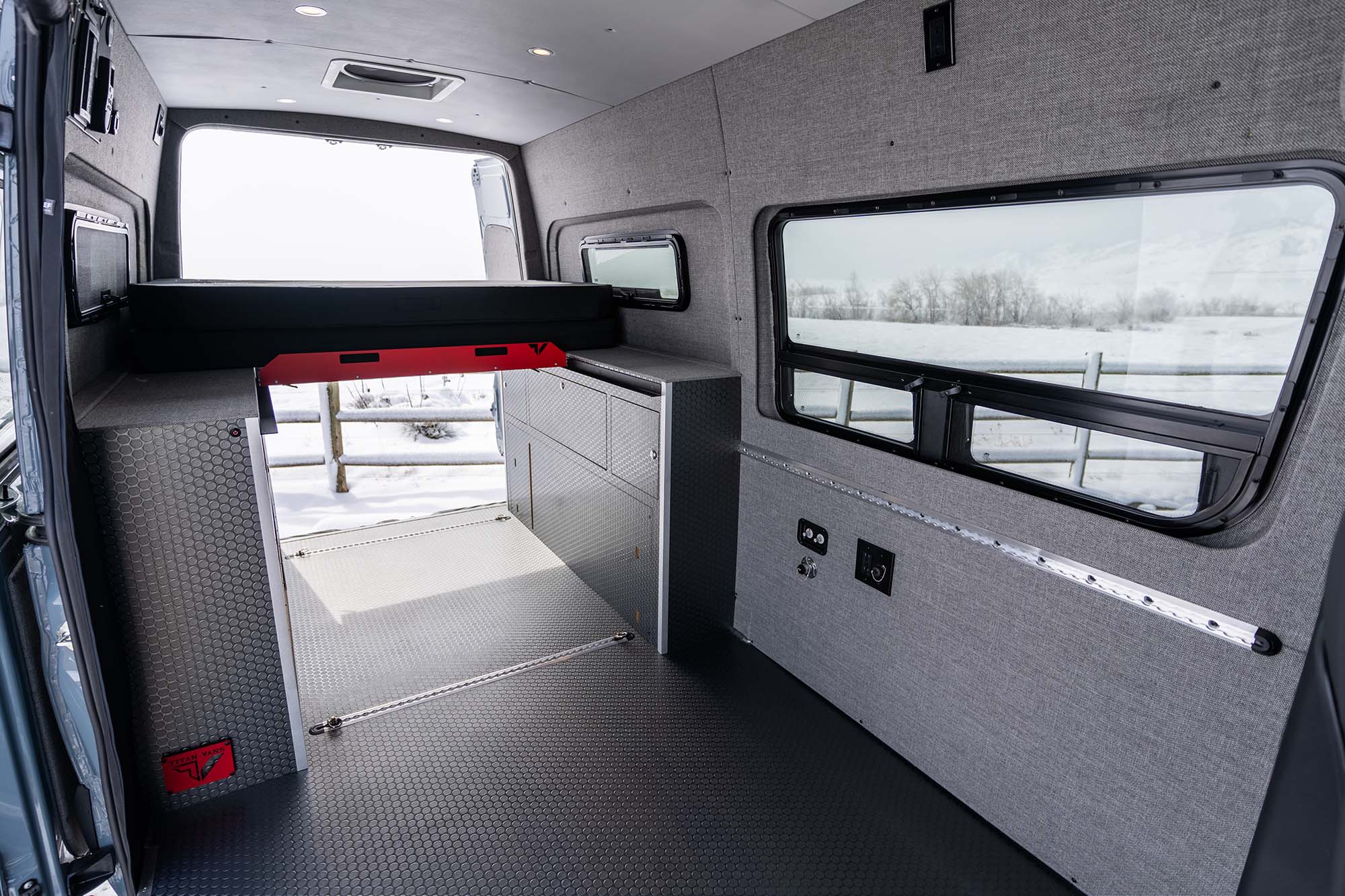 The Classic camper van's interior space showing the bed are and the front part of the living space