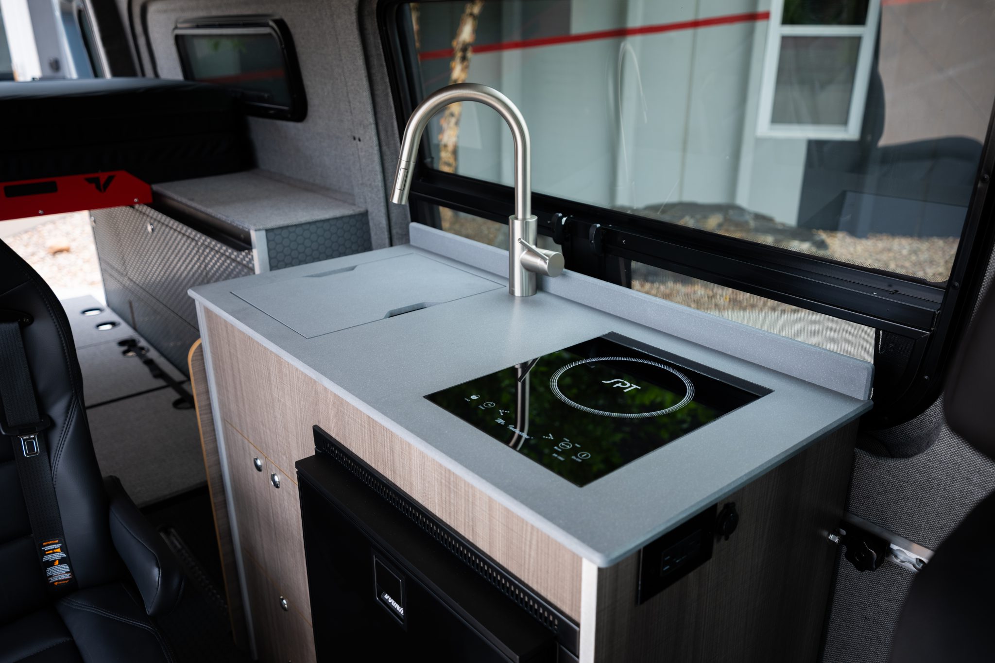Camper van kitchen galley with sink and induction cooktop