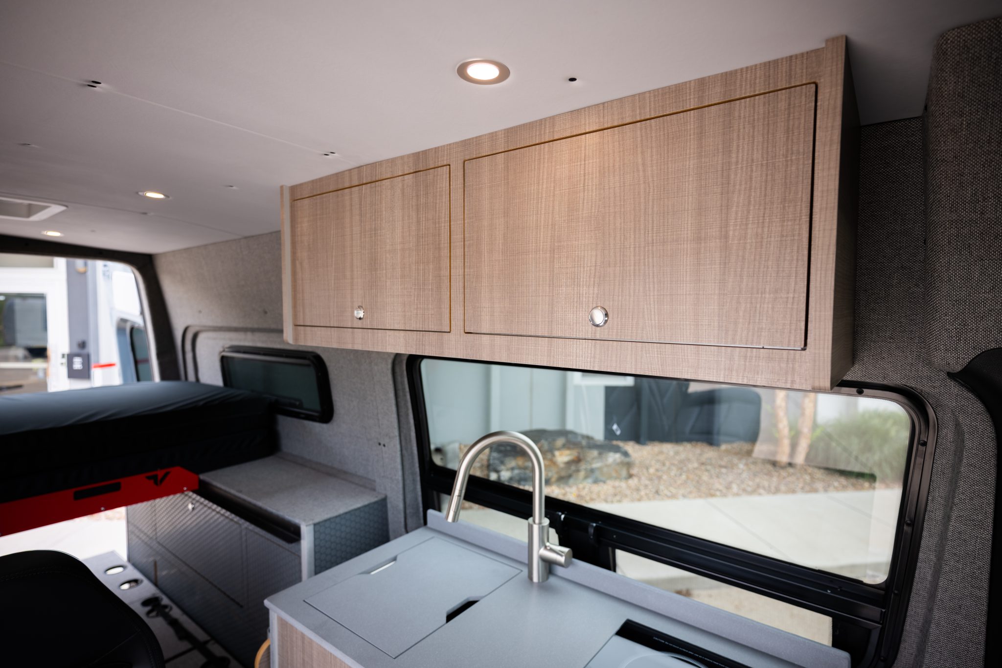 Camper van overhead cabinets above the kitchen galley