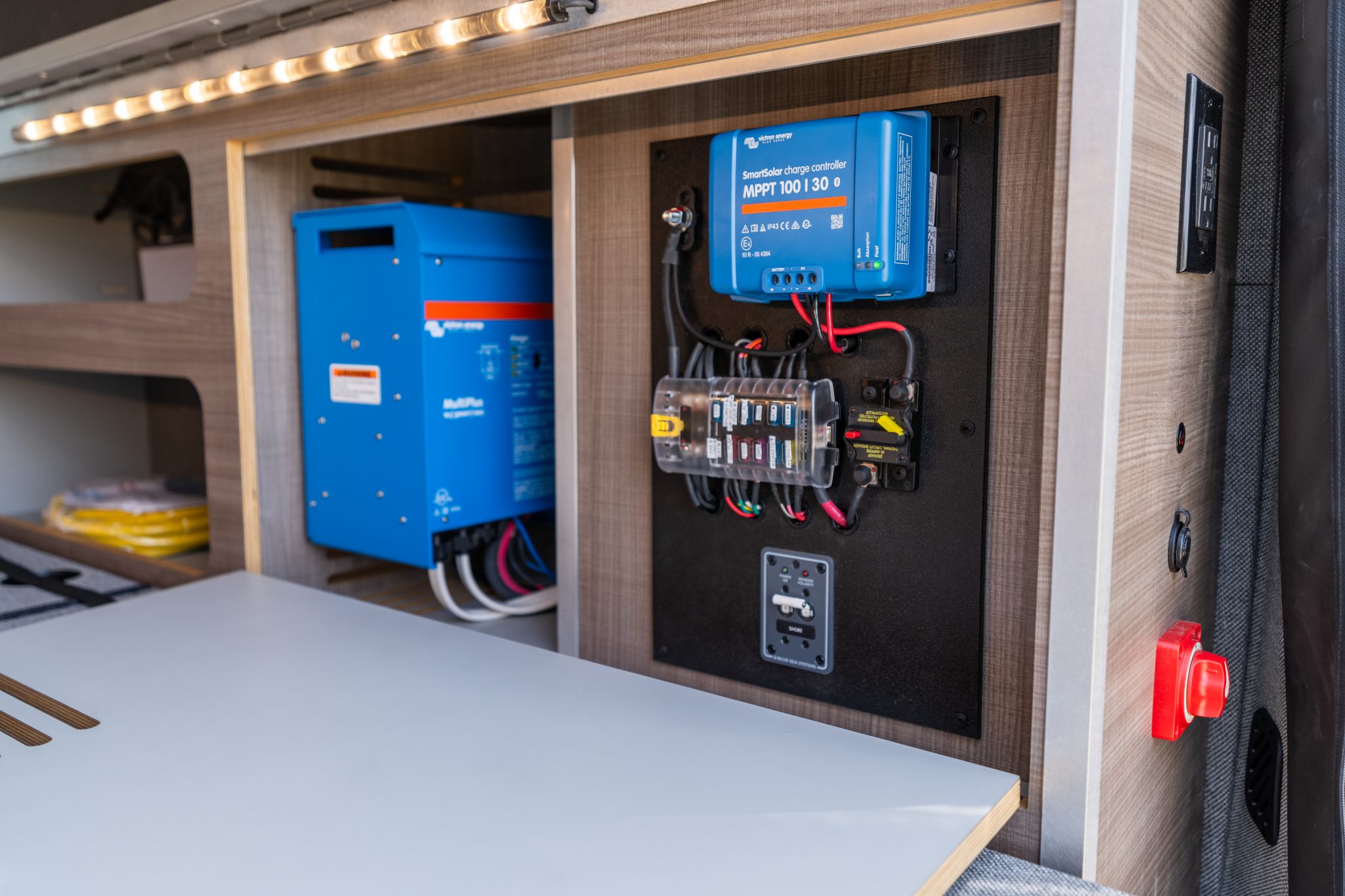 Camper van electrical bay with the inverter, solar charge controller and fuse panel