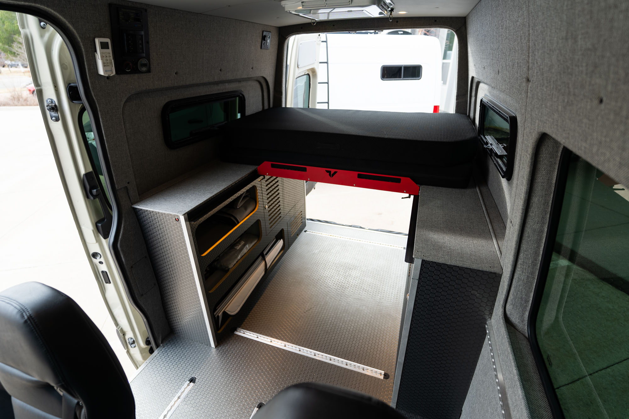 camper van wheel well bi-slide bed system