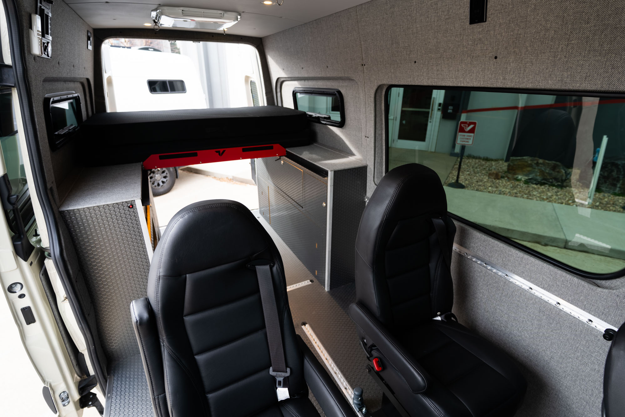 camper van bed and seats in living area