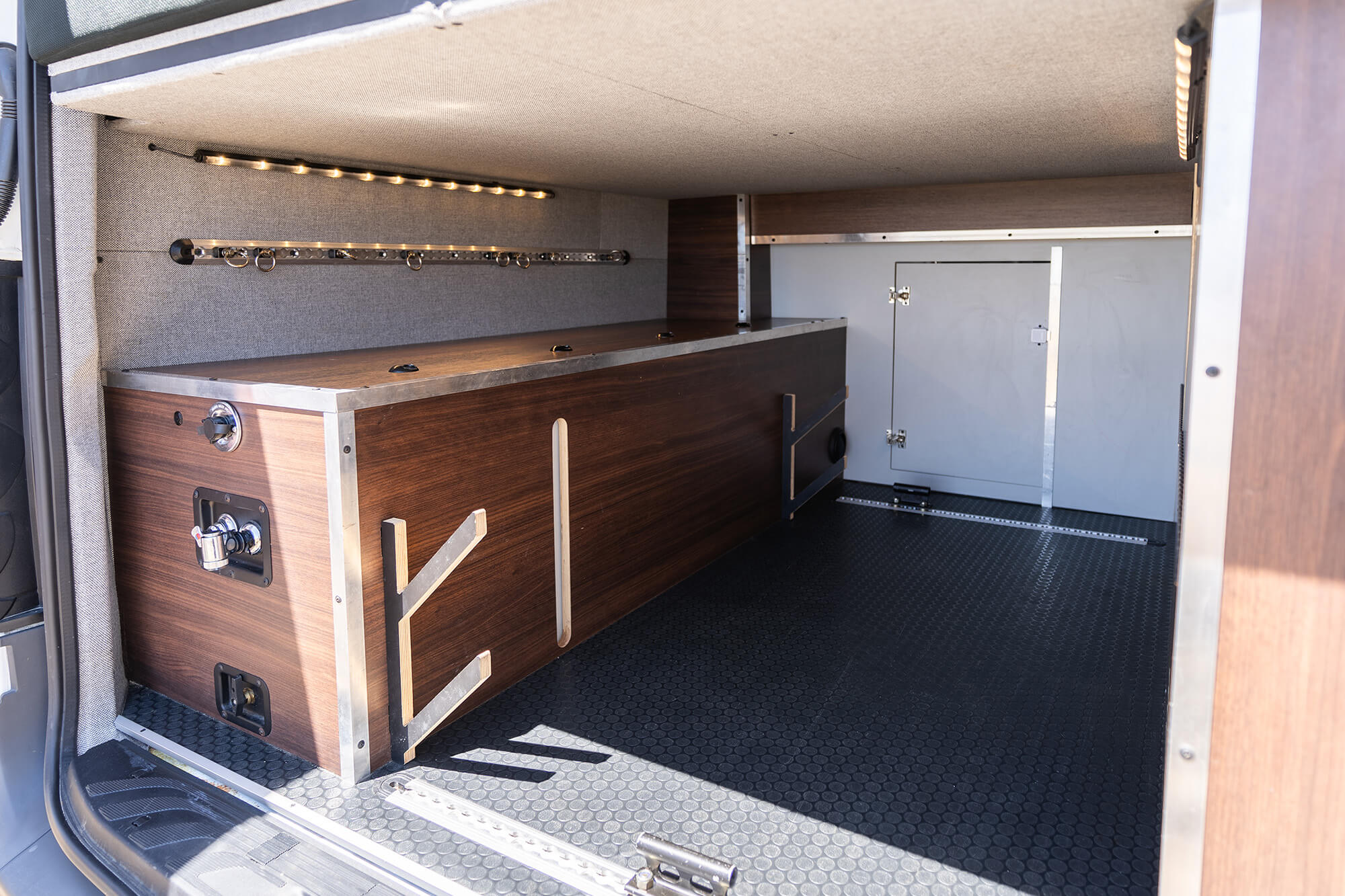 Camper van garage with spray down shower