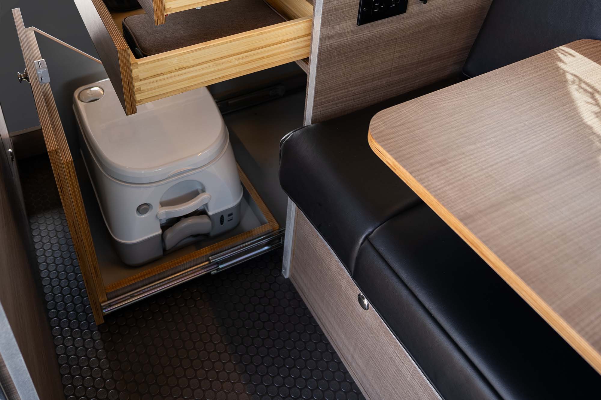 Slide-out cassette toilet cubby in the Metis camper van