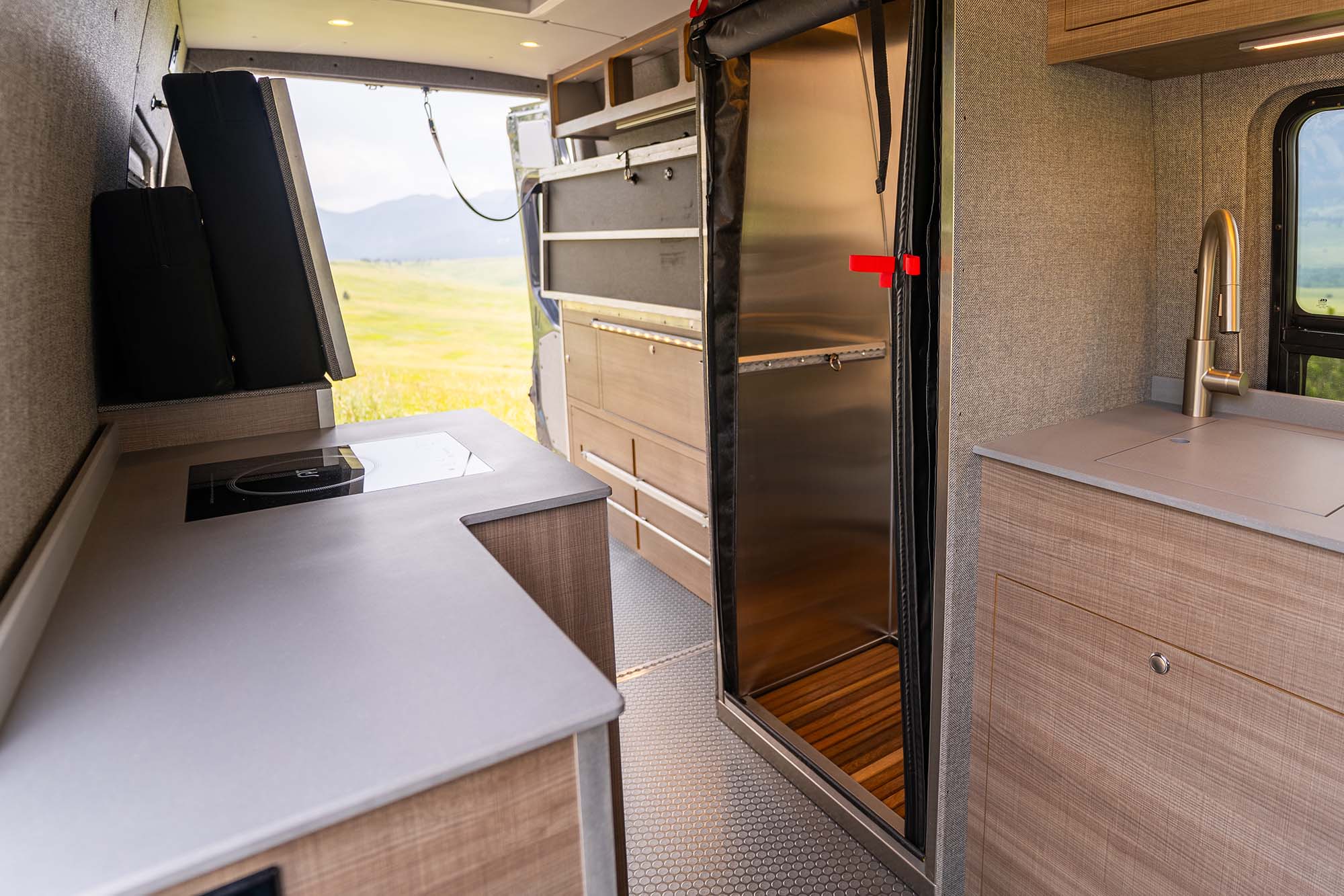 The shower and legless murphy bed system in the back of an Ultra camper van