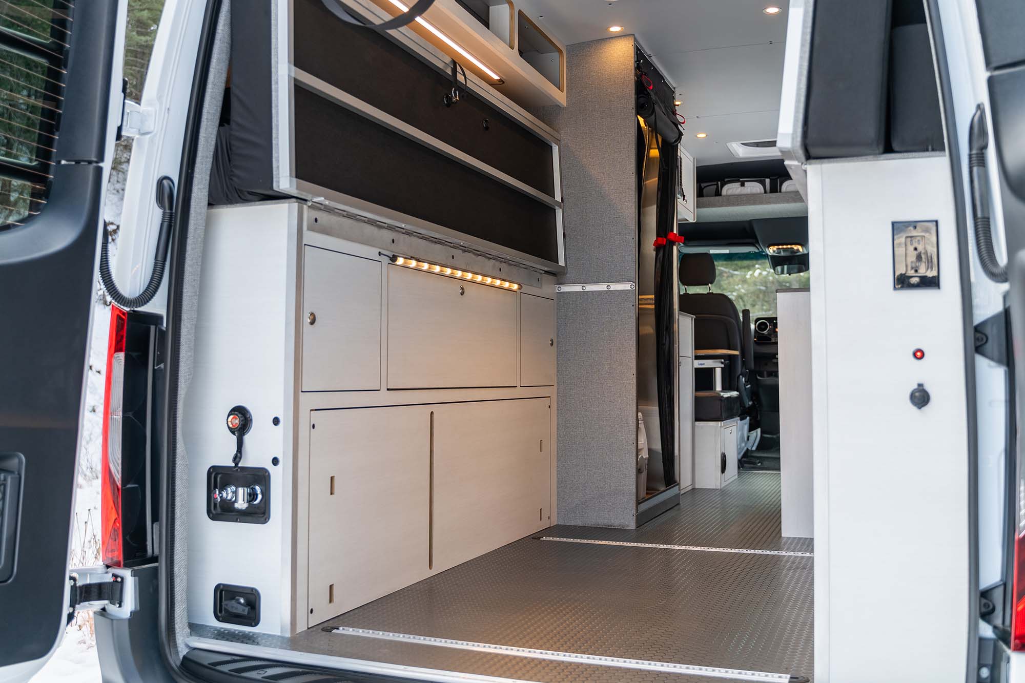 The back of the camper van's wheel well bed system